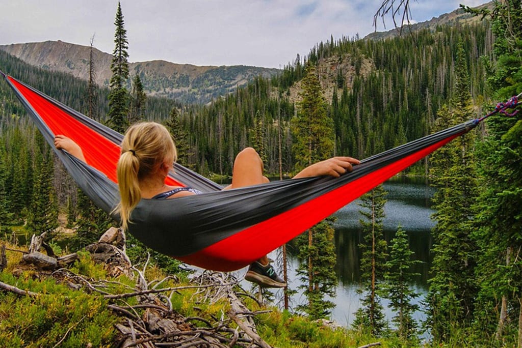 Woman in hammock looking at mountains